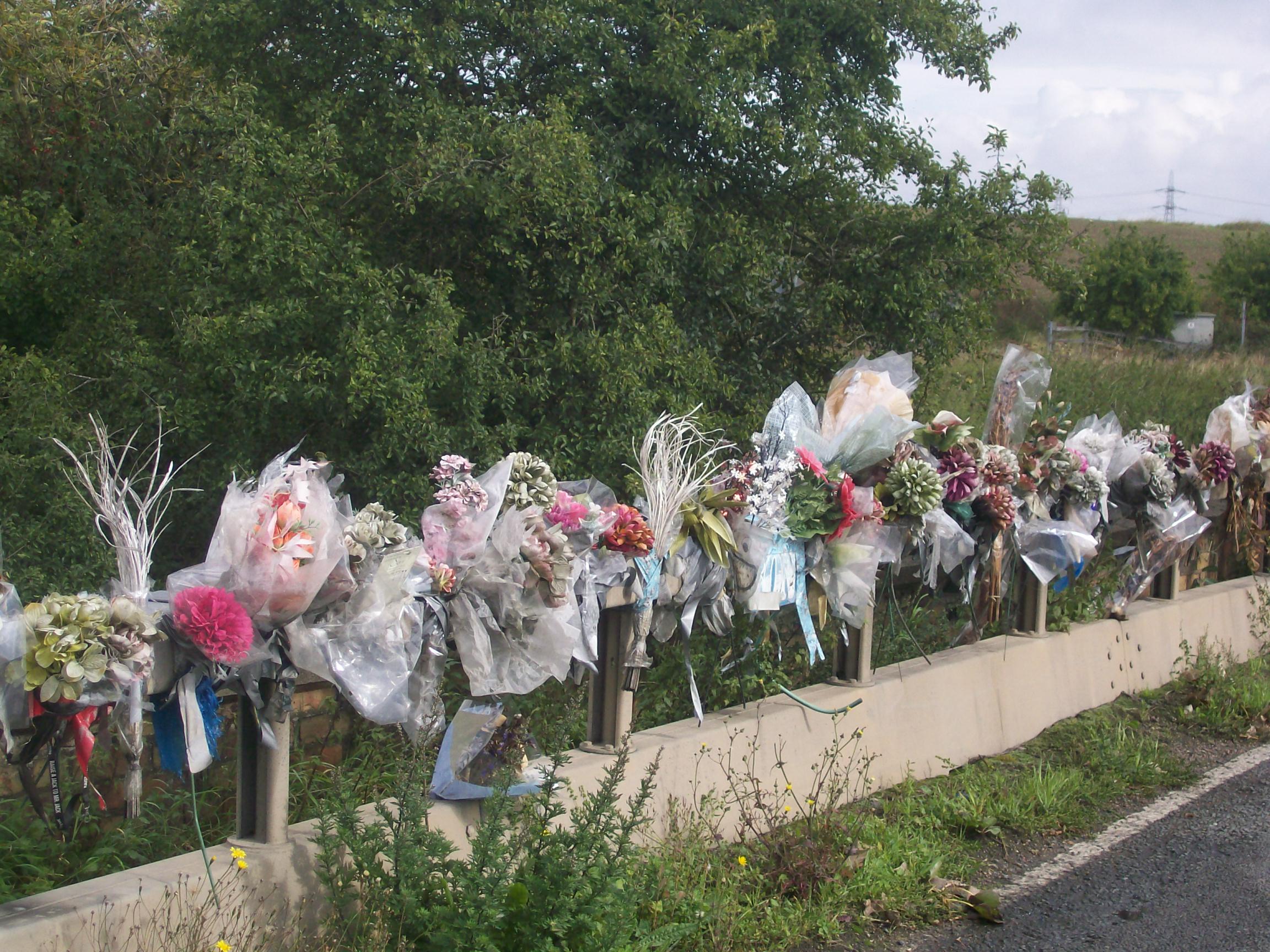 Flowers marking the spot of a fatal road accident. See Photo Credits.