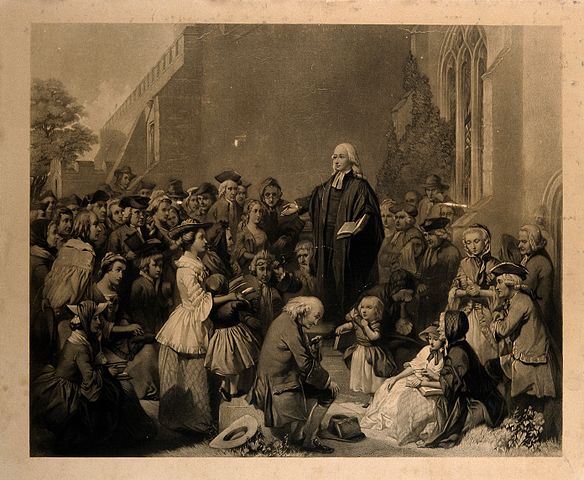 John Wesley, preaching outside the church walls. See Photo Credits.