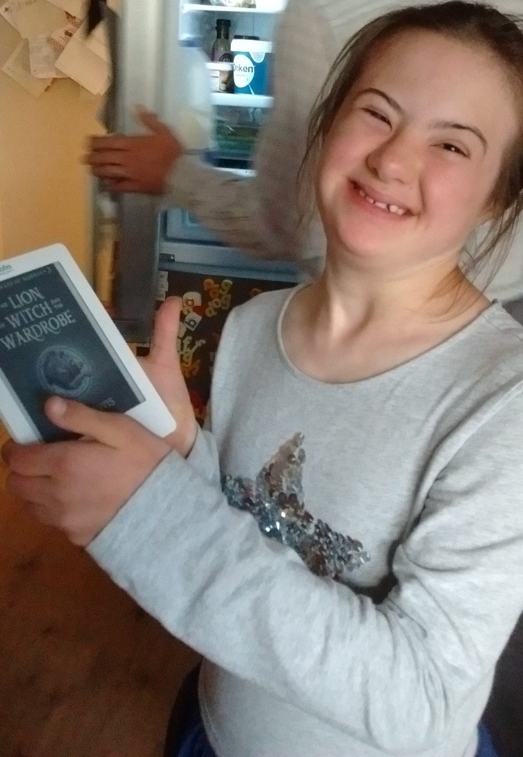 Emily enjoys reading to herself on her e-reader, given to her by a friend at church, which allows her to enlarge the text