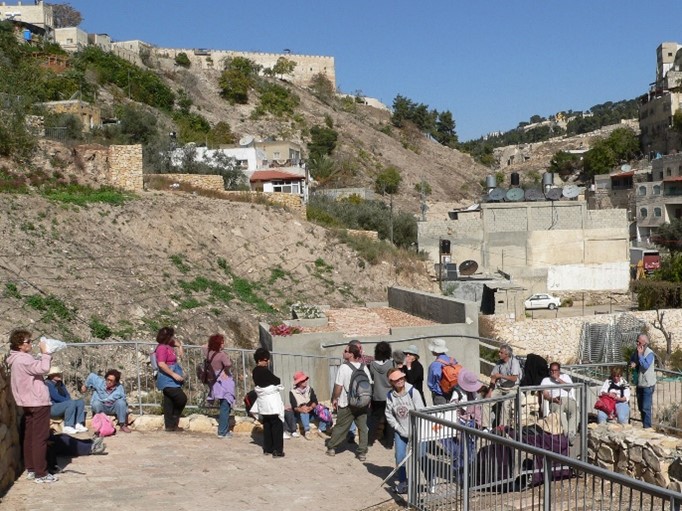  A tour group above the modern entrance to Gihon spring, 2006.  The City of David is uphill on the left (photo by D Longworth).)