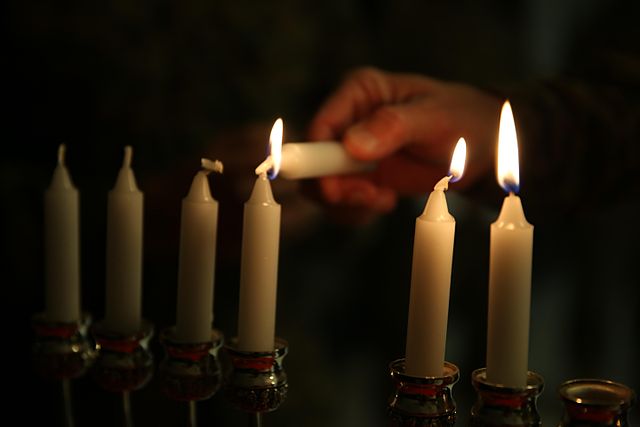 Hanukkah candles being lit by the 'servant' candle, or shammash