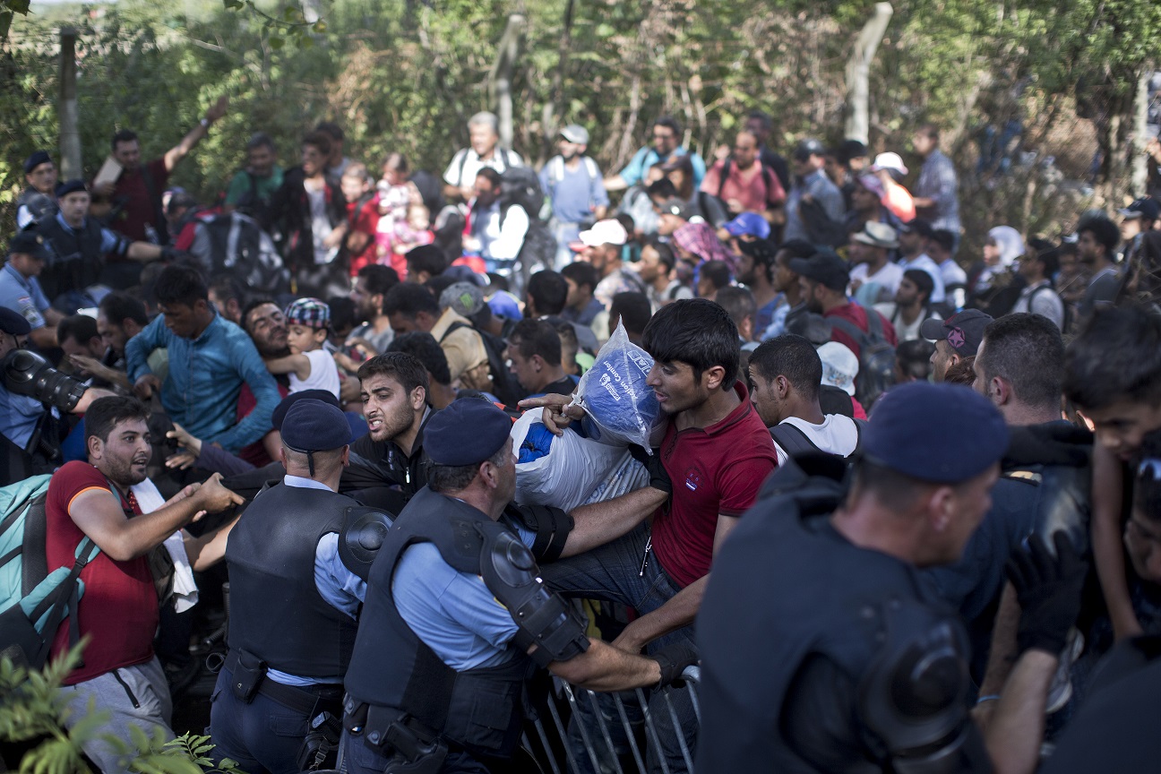 Migrants push through a police line in Croatia on Thursday.