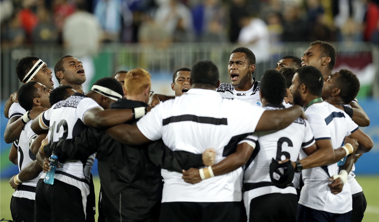 The Fiji sevens pray after their gold medal win.