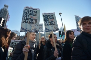 Pupil placards read: &#039;System change not climate change. One solution: revolution&#039;