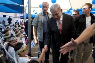 Israeli Prime Minister Netanyahu greets a pupil on 1st day of school