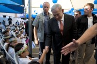 Israeli Prime Minister Netanyahu greets a pupil on 1st day of school