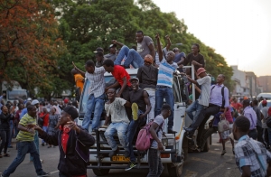 Zimbabweans celebrate the departure of Robert Mugabe. See Photo Credits.