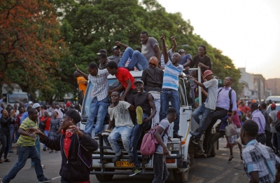 Zimbabweans celebrate the departure of Robert Mugabe. See Photo Credits.