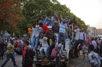 Zimbabweans celebrate the departure of Robert Mugabe. See Photo Credits.