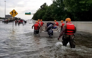 The Texas Army National Guard move through flooded Houston streets.