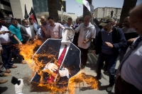 Palestinians burn a cutout of US Secretary of State Mike Pompeo