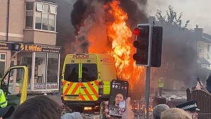 A police van on fire during the riots in Southport