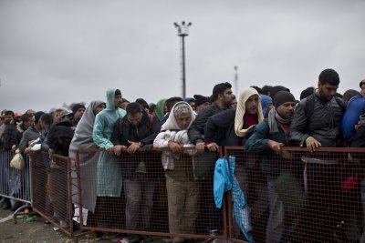 Migrants queue outside a reception centre in Croatia, 25 September 2015.