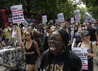 Demonstraters march in central London, Wednesday.