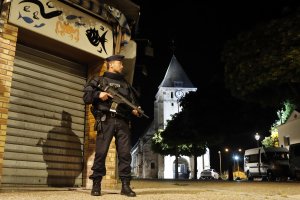 French police guard the Normandy church attacked on Tuesday. See References.