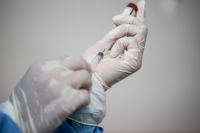 Nurse putting a vaccine fluid into a syringe (Donal Husni/NurPhoto/PA Images).